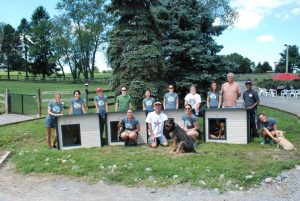 After completing the doghouses, employees from Evolve IP showed off their handy work to the rescue dogs on the property.