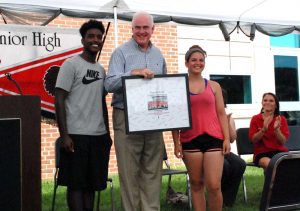 Kameron Reeves and Sarah Morroney, drum majors for the marching band, presented Meehan with a framed picture, signed by all band members.
