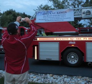 KAU Coach Chris Jarmuz snaps a photo of the banner decorating the Kennett Fire Company truck.