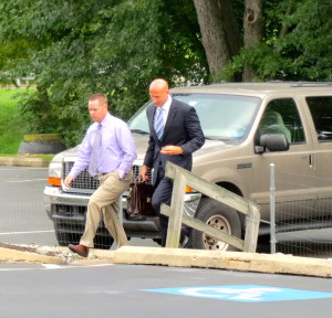 Accompanied by his attorney, Daniel R. Bush (right), Gerald D. Pawling, a former Coatesville detective, arrives at Caln district court for his arraignment on theft charges.