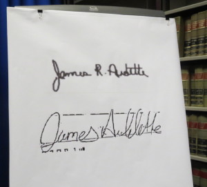 Hogan displays the signature (top) of Coatesville Police Lt. James Audette. Below it is an alleged forgery by Pawling in which the name is misspelled.