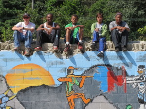 The ServiceCorps crew takes a moment to relax after finishing an ambitious wall mural that features selected  Waste Oil Recyclers’ employees as “superheroes.”