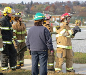 Mo Lahloui (right), 17, of Parkesburg, takes his turn getting used to the force of the nozzle as instructor Reenie McCormick (dressed in blue) looks on.