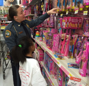 Coatesville Det. Shannon Miller offers assistance to her shopper in the popular Barbie section. 