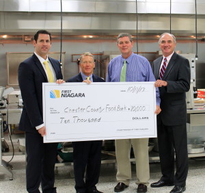 First Niagra's Allan Burkley (from left) poses with Robert MacNeil, board chairman of the Chester County Food Bank, Larry Welsch, its  and Bob Kane.