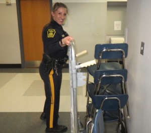 Kennett Square Police Officer Sarah London moves furniture into her small corner office at Kennett High School. 