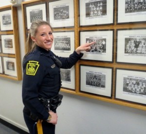 Kennett Square Police Officer Sarah London, the new school resource officer at Kennett High, points to a 2001 photo that shows her on the school’s cheerleading squad.
