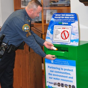 Coatesville Police Sgt. Rodger Ollis demonstrates the ease with which residents can dispose of unused medication.