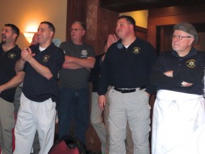 Kenneth Rongaus (right) and the crew of deputy sheriffs are applauded after the meal.