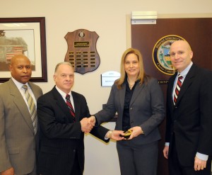 New Chester County Detective Kristen Lund is congratulated by Lt. Kevin Dykes (from left), Chief Detective James Vito, and District Attorney Tom Hogan.