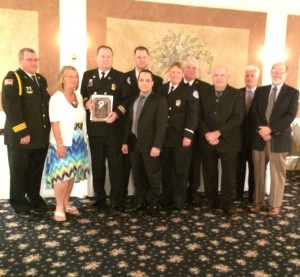 Members of the Southern Chester County Emergency Medical Services - Medic 94 pose with the award they received for distinguished service.