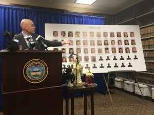 Calling the bust the largest in county history, District Attorney Tom Hogan displays photos of 44 defendants taken into custody for their roles in a Mexican cocaine cartel.