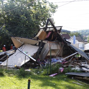 Remains of the exploded house sit in a heap.