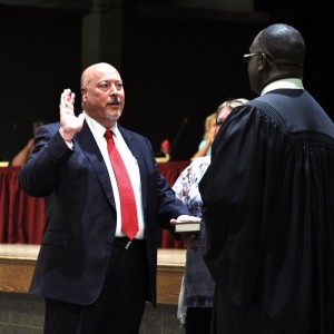 Dean Snyder is sworn into school board position by Judge Gregory Hines.