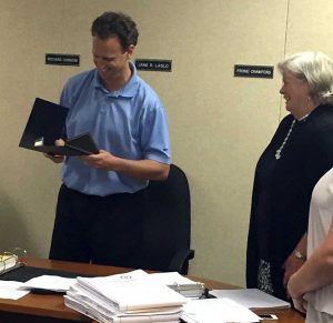 East Marlborough Supervisors Chair Richard Hannum reads a proclamation honoring the retiring Township Manager, Jane Laslo, Monday night.
