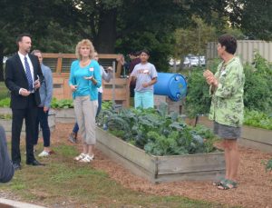 Patton Middle School teacher Betsy Ballard talks about the history of green efforts at the school dating back to 2010, as prinicipal Tim Hoffman (left) and Phoebe Kittson (right) of the Chester County Food Bank look on.