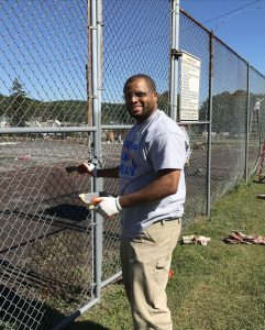 Coatesville resident Courtney Allen volunteered his time by painting the fence around the tennis courts at the park.