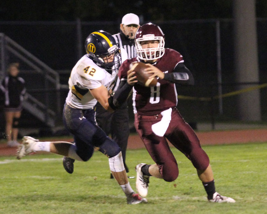 Unionville's James Watson closes in on Oxford quarterback Chandler England. Jim Gill photo.